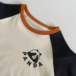 Detail of children's panda raglan T-shirt showing orange collar and cotton fabric texture