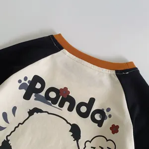 Detail of raglan sleeves and cute panda print on a cotton toddler t-shirt