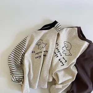 Detail view of cotton kids shirts with contrast sleeves and cute cartoon dog print