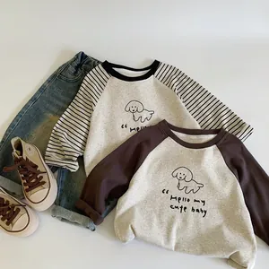 Flat lay of cotton kids raglan sleeve T-shirts with cute dog print and denim pants
