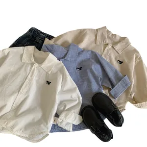 Set of minimalist long sleeve button-up shirts for kids with animal embroidery detail