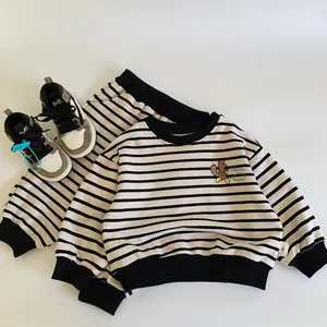 Detail of baby striped cotton sweatshirt and pants set with little fox cartoon print