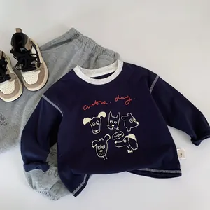 Detailed flat lay of navy blue long sleeve toddler T-shirt with cute dog print and grey pants
