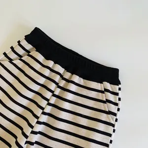 Kids black and white striped casual pants with elastic waist and side pockets