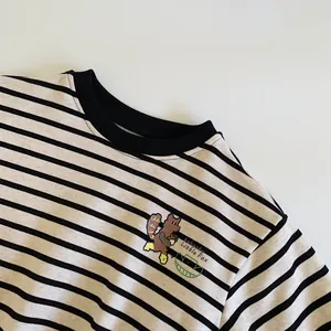 Detail of baby striped sweatshirt showing ribbed neckline and little fox cartoon pattern