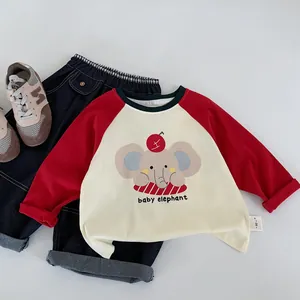 Flat lay of baby elephant cartoon long sleeve tee and dark blue denim jeans with 90 size label