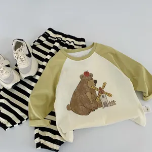 Detailed flat lay of long-sleeve cotton T-shirt with bear print and striped pants