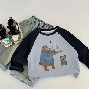 Flat lay of kids long sleeve bear print top and light wash denim jeans set