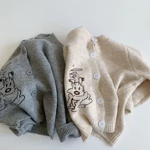 Detail of grey and beige knit cardigans with cute dog embroidery and button closure