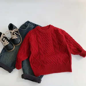 Close-up of red cable-knit texture and ribbed cuffs on kids thick winter sweater