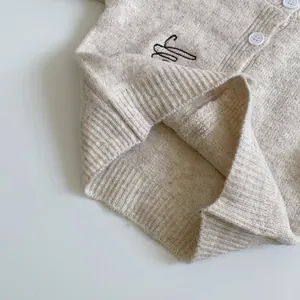 Beige knit cardigan for kids featuring puppy embroidery and ribbed hem details