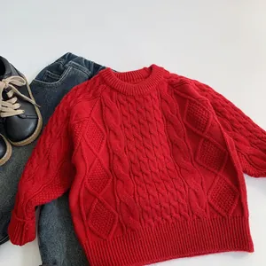 Detail view of red cable knit sweater featuring classic textured patterns for children