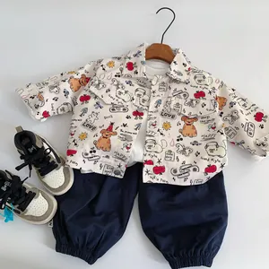 Detail of toddler outfit featuring graffiti jacket, cargo pants, and color-block sneakers