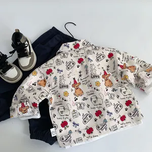 Close-up of children's cotton jacket featuring all-over cute cartoon puppy and apple prints