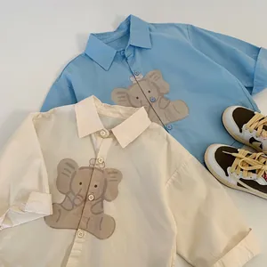Detail of children cotton shirts with cute cartoon elephant prints and polo collar style