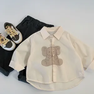 Detailed flat-lay of kids beige cartoon elephant shirt and charcoal casual trousers