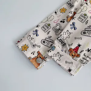 Detailed macro shot of cotton baby shirt cuff with cute dog print and silver button