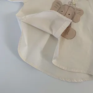 Kids beige cotton shirt with cute elephant print and curved hem detail for spring