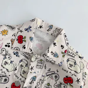 Detail of baby denim jacket with cute cartoon dog print and silver fashion buttons