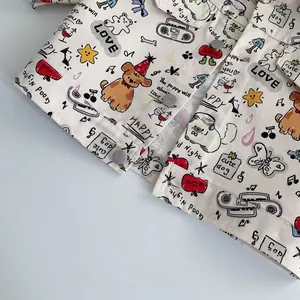 Detail of baby denim jacket with cute cartoon graffiti prints and silver metal buttons