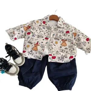Toddler spring outfit featuring cream cartoon print jacket and navy joggers on hanger