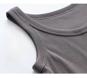 Detailed macro view of dark grey ribbed cotton fabric showing high elasticity and stitching