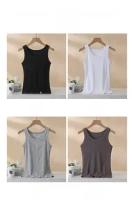 Detail view of ribbed cotton tank tops in black, white, and gray on wooden hangers