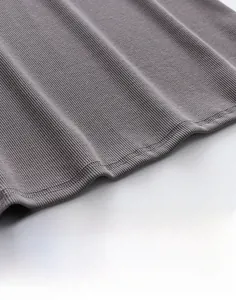 Macro detail of high-quality double-needle stitching on grey ribbed cotton vest hem
