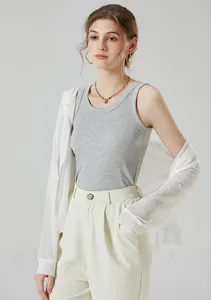 Detail of ribbed cotton tank top paired with a sheer lightweight white cardigan