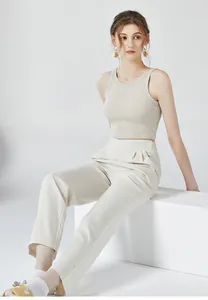 Détail du débardeur côtelé beige avec coussinets et pantalon blanc à taille haute