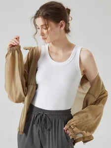 Women's white ribbed tank top with brown jacket and grey joggers set in studio view