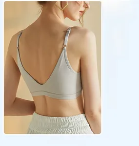 Detail of light grey seamless tank top featuring a deep V-shaped open back design