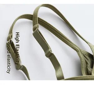 Detailed close-up of high-stretch straps and ribbed knit fabric on olive green camisole