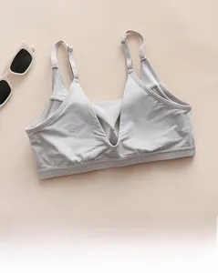 Detail of light grey seamless tank top featuring a deep V-back design and thin straps