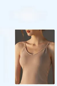 Detail showing the deep V-neck and thin straps of a beige modal camisole with built-in pads