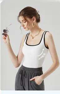 Détail du débardeur blanc ajusté avec bordure noire et coussinets de soutien