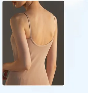 Detail view of the elegant open-back design and thin straps on a beige modal camisole