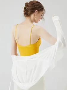Back view of a yellow ribbed camisole with a white hooded sun protection jacket