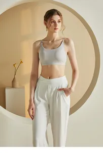 Detail of grey seamless V-back camisole with thin straps and criss-cross high waist pants