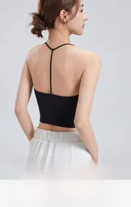Detail of black Y-back bra top featuring slim straps and a textured ribbed fabric