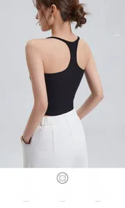 Close-up of black ribbed racerback tank top showing deep open back design and texture