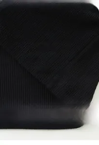 Macro texture of black ribbed fabric showing moisture-wicking and durable fibers