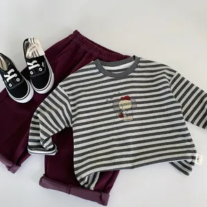 Close-up of boys' cotton striped T-shirt with elephant print and burgundy pants set