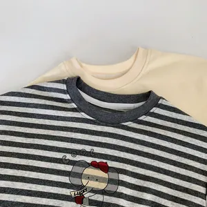 Close-up of boys' cotton T-shirts featuring striped fabric and a cute cartoon elephant print