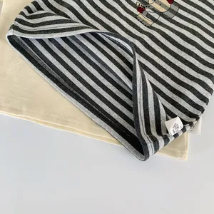 Detail of boys striped elephant shirt showing the double-stitched hem and wash label