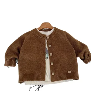 Classic dark brown knitted cardigan for children with wooden buttons and ribbed cuffs