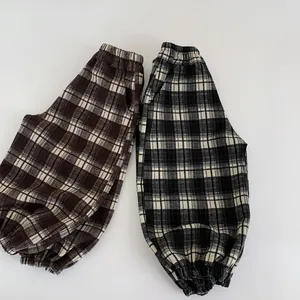Kids plaid jogger pants with elastic waist in brown and black checkered patterns