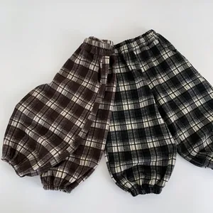 Detail of elastic waist and ribbed cuffs on kids' plaid loose casual joggers