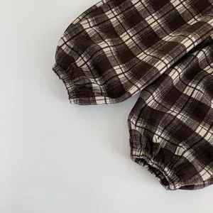 Detailed close-up of the elastic cuff on brown checkered children pants for toddlers