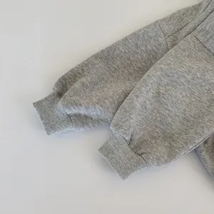Detailed close-up of melange grey hoodie sleeve with high-quality ribbed knit cuff finish